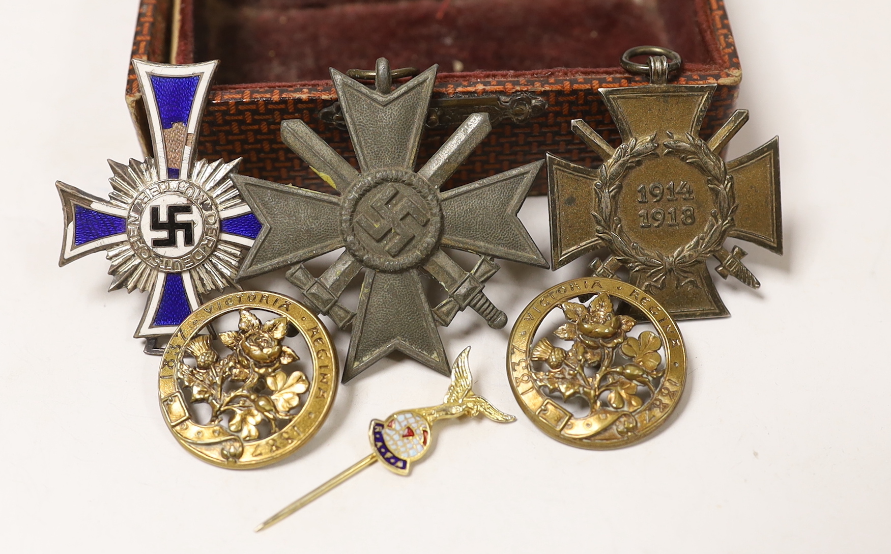 A WW1 Hindenburg Honour Cross A WW2 Silver German Mothers Cross showing some damage (for producing 6 or more children), a WW2 bronze Military War Merit Cross (with Swords) a small RAFA lapel badge, two gilt? badges comme